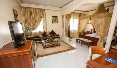 a large room with a bed and a living room at Zalagh Parc Palace in Fès