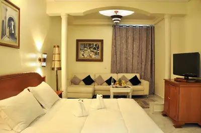 a hotel room with a bed and a couch at Zalagh Parc Palace in Fès