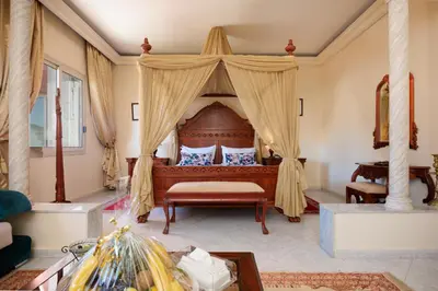 a bedroom with a bed with a canopy at Zalagh Parc Palace in Fès