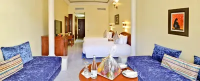 a hotel room with two blue couches and a bed at Zalagh Parc Palace in Fès