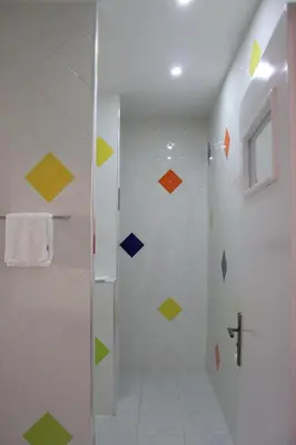 a bathroom with a shower with colorful tiles at Auberge Tinit in Er Rachidia