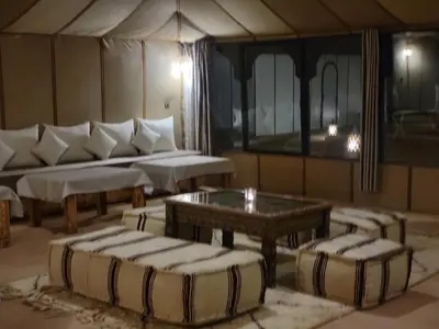 a living room with a couch and a table at Ammar Luxury Camp in Merzouga