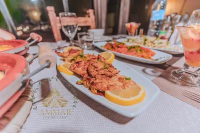 a plate of food on a table with plates of food at Ammar Luxury Camp in Merzouga