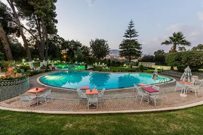 a swimming pool with tables and chairs in a yard at Menzeh Zalagh 2Boutique Hôtel & Sky in Fès