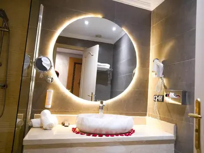 a bathroom with a round sink and a mirror at Menzeh Zalagh 2Boutique Hôtel & Sky in Fès