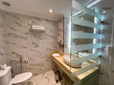 a bathroom with a toilet and a glass shower at Menzeh Zalagh 2Boutique Hôtel & Sky in Fès