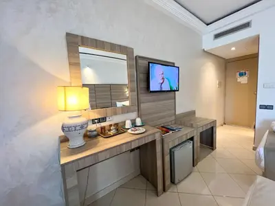 a room with a desk with a tv on the wall at Menzeh Zalagh 2Boutique Hôtel & Sky in Fès