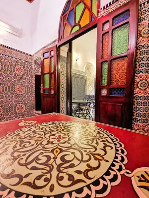 a room with a table with a design on it at Riad Farah in Fès
