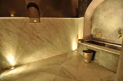 an empty hallway with a trash can and lights at Riad Layla in Fès