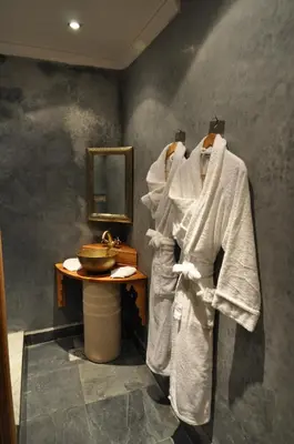 a bathroom with white towels hanging on a wall at Riad Layla in Fès