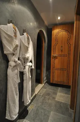 a room with white robes hanging on a wall at Riad Layla in Fès