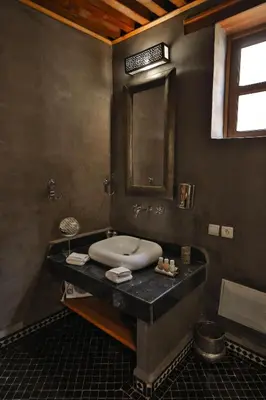 a bathroom with a sink and a mirror at Riad Layla in Fès