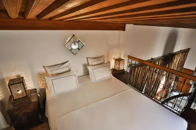 a living room with a white couch and a staircase at Riad Layla in Fès
