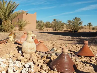 a group of vases sitting on a pile of rocks at Camping Les Palmeraies - Oasis Escape Tagounite in Tagounite
