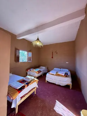 a room with three beds in it with a ceiling at Camping Les Palmeraies - Oasis Escape Tagounite in Tagounite