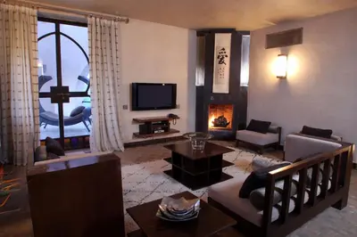a living room with a couch and a fireplace at O'Atlas in El Harkat