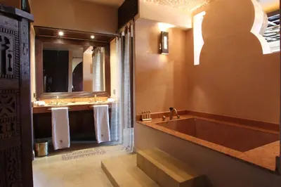a bathroom with a large tub and a sink at O'Atlas in El Harkat