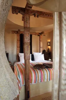 a bedroom with a bed with a wooden bed frame at O'Atlas in El Harkat
