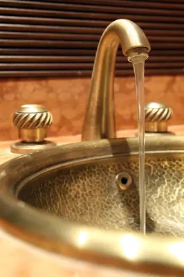 a bathroom sink with water coming out of it at O'Atlas in El Harkat