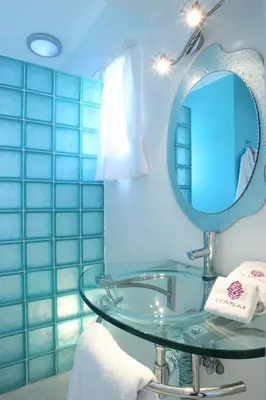 a bathroom with a glass sink and a mirror at O'Atlas in El Harkat