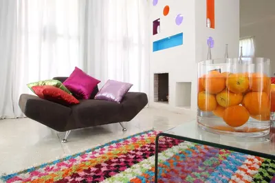 a living room with a couch and a vase of oranges at O'Atlas in El Harkat