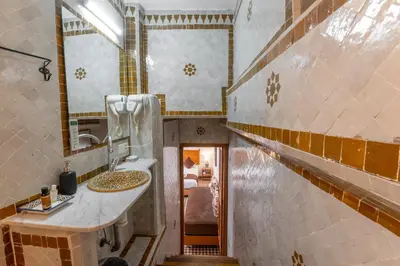a bathroom with a sink and a mirror at Dar D'or Fes in Fès