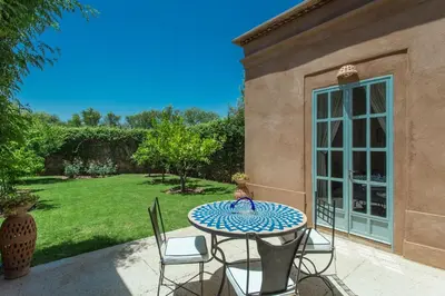 a table and chairs on a patio at Villa Akhdar 18 in Ben Larbi