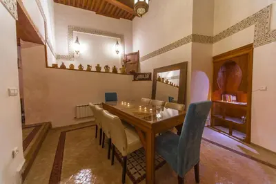 a dining room with a wooden table and chairs at Riad Said in Fès