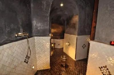 a bathroom with a shower and a tiled floor at Riad Said in Fès