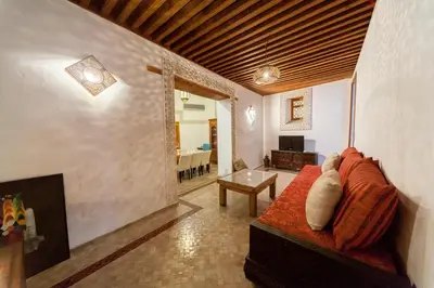 a living room with a couch and a fireplace at Riad Said in Fès