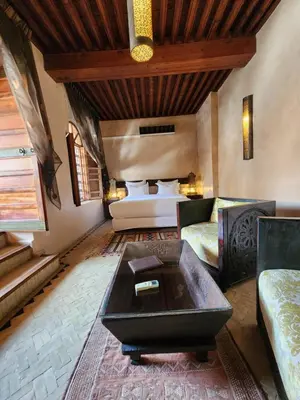 a living room with a bed and a coffee table at Riad Said in Fès