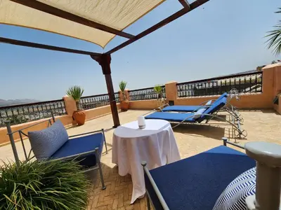 a patio with a table and chairs on a balcony at Riad Said in Fès