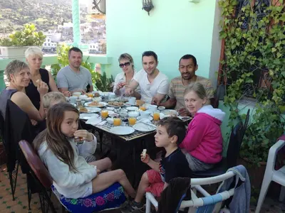 a group of people sitting around a table at Al Andaloussiya Diyafa in Moulay Idriss Zerhoun