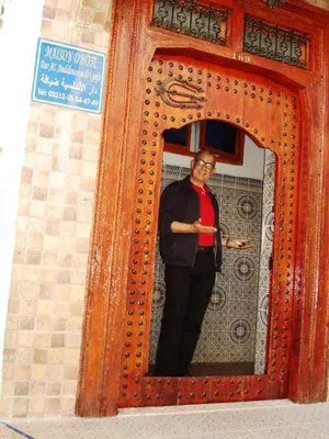 a man standing in front of a mirror at Al Andaloussiya Diyafa in Moulay Idriss Zerhoun
