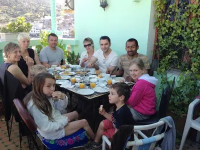 a group of people sitting around a table at Al Andaloussiya Diyafa in Moulay Idriss Zerhoun