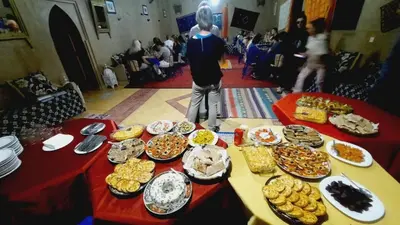 a table full of plates of food on a table at Hôtel Riad Tadarte Familier in Merzouga