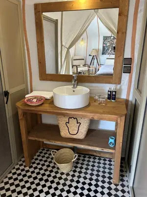 a bathroom with a sink and a mirror at Desert Luxury Camp Merzouga in Merzouga