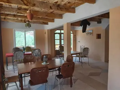 a dining room with wooden tables and chairs at kasbah Ait arbi in Aït Ougliff
