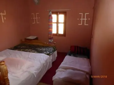 a room with two beds and a window at kasbah Ait arbi in Aït Ougliff