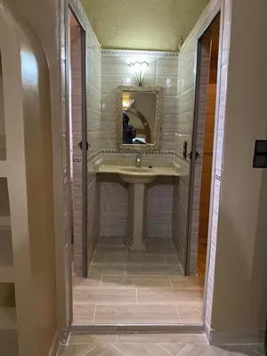 a bathroom with a sink and a mirror at Sunny Place apartments in Merzouga