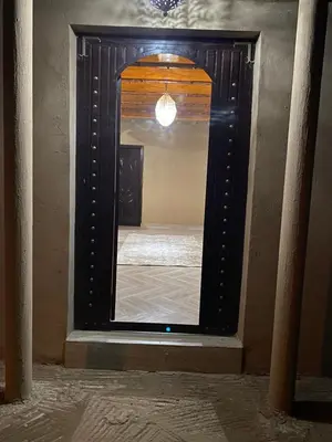a mirror in a room with a bed in it at Sunny Place apartments in Merzouga