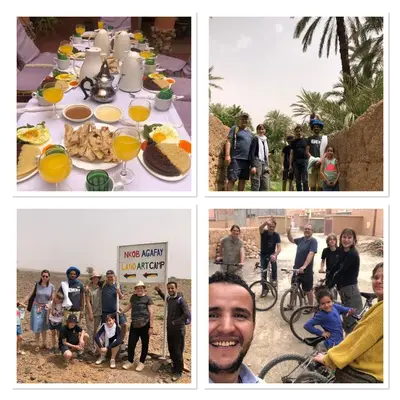 a group of people standing around a table with food at Riad Nkob in Nkob