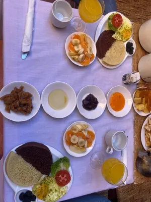 a table with many plates of food on it at Riad Nkob in Nkob