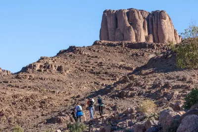 a group of people walking on a rocky mountain at Riad Nkob in Nkob