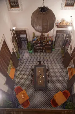 an overhead view of a living room with a table and chairs at La Cheminée Bleue Fes in Fès