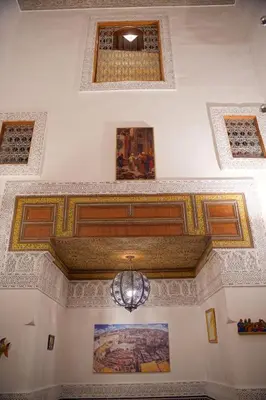 a ceiling of a building with a chandelier at La Cheminée Bleue Fes in Fès