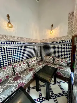 a living room with a couch and a table at Dar atlas in Fès