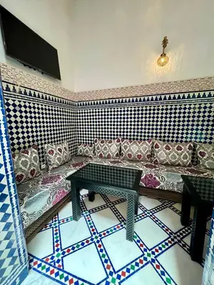 a living room with a couch and a table at Dar atlas in Fès