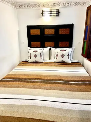 a bedroom with a large bed with pillows at Dar atlas in Fès