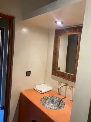 a bathroom with a sink and a mirror at Kasbah Erg Chebbi in Merzouga